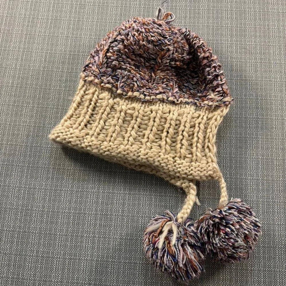 Multicolored knitted hat with pom poms